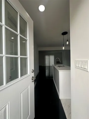 a kitchen with a refrigerator and a sink