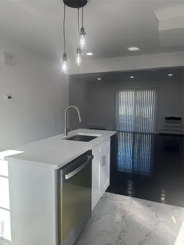 a kitchen with a sink and chandelier