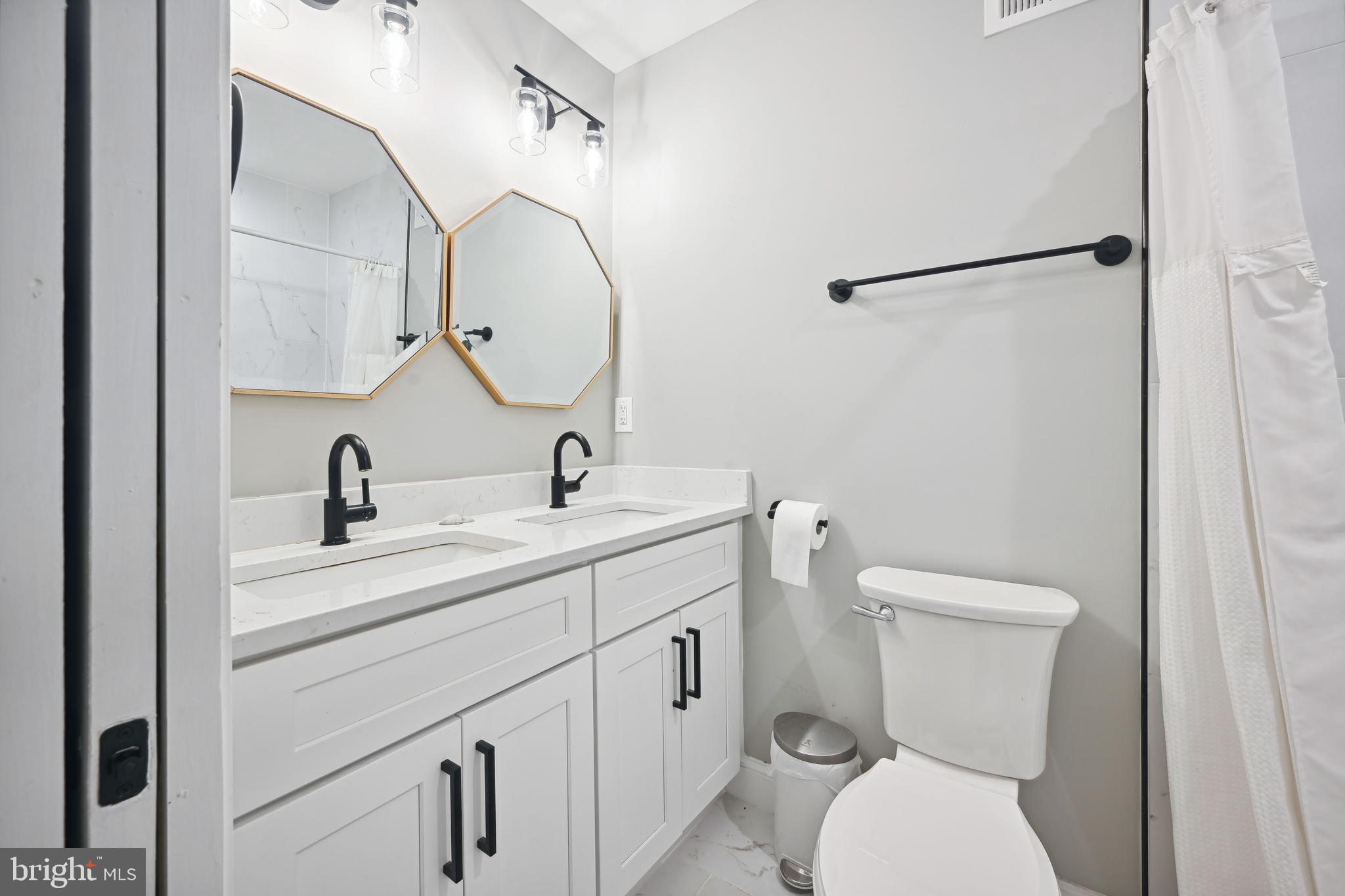 1732 L Street Northeast Washington, DC 20002 - Photo 12 of 20 a bathroom with a toilet sink and mirror