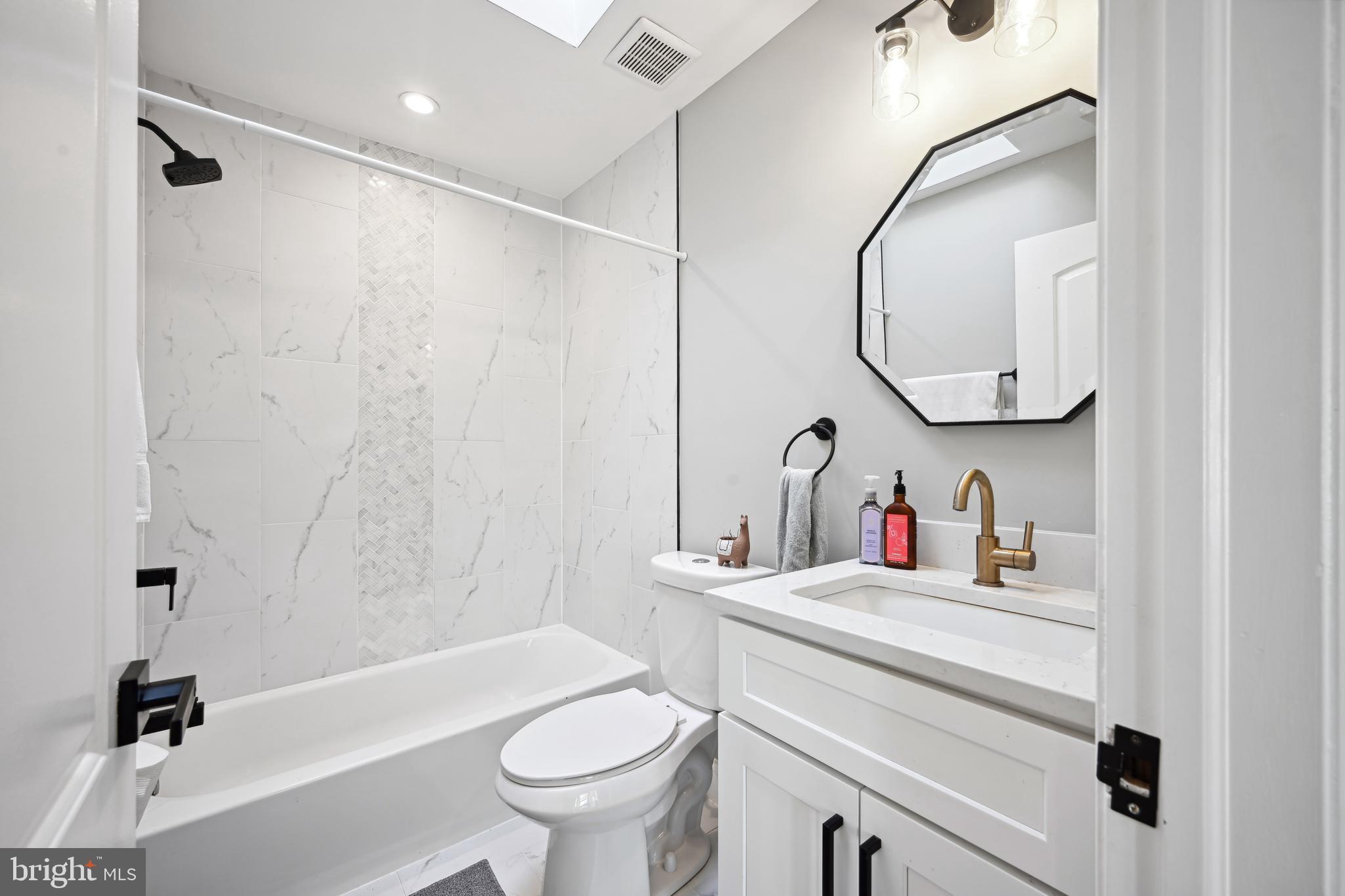 1732 L Street Northeast Washington, DC 20002 - Photo 15 of 20 a bathroom with a sink a toilet and a mirror