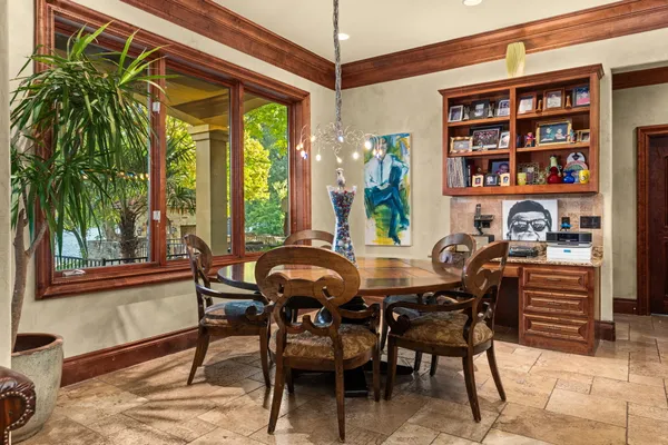 a dining room with furniture and a floor to ceiling window