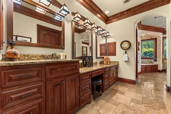 a spacious bathroom with a granite countertop sink and a mirror