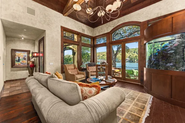 a living room with furniture and large windows