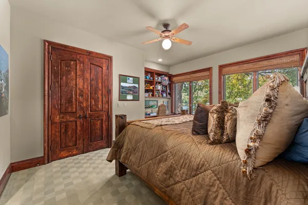 a bedroom with a large bed and a chandelier
