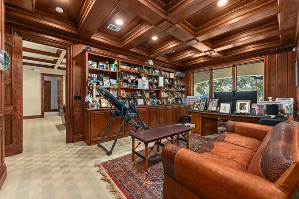 a living room with furniture a ceiling fan and a rug