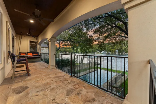 a view of swimming pool with seating area and trees around