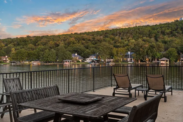 an aerial view of ocean and residential houses with outdoor space