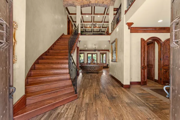 a view of entryway and hall with wooden floor