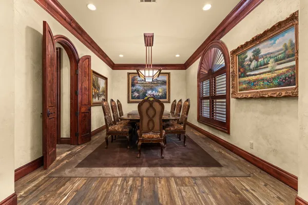 a dining room with furniture entryway and wooden floor