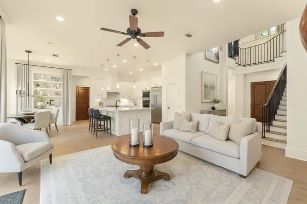 a living room with furniture a fireplace and a chandelier
