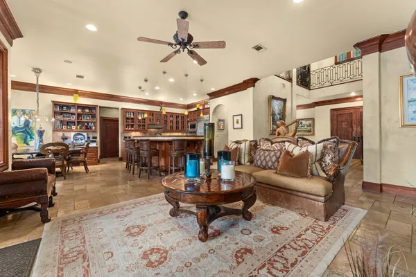 a living room with furniture and a view of kitchen