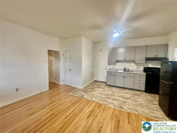 a view of a kitchen with wooden floor