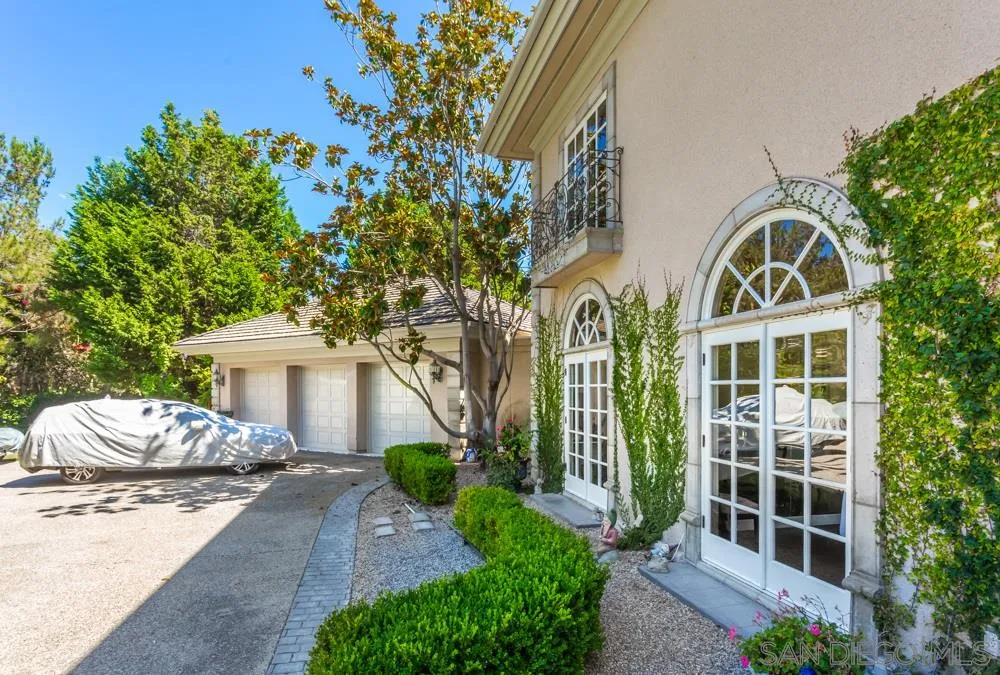6645 Via Dos Valles Rancho Santa Fe, CA 92067 - Photo 14 of 20 a front view of a house with a garden