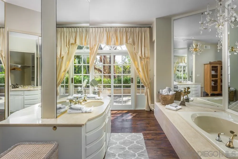 6645 Via Dos Valles Rancho Santa Fe, CA 92067 - Photo 15 of 20 a bathroom with a sink a large mirror and a bathtub