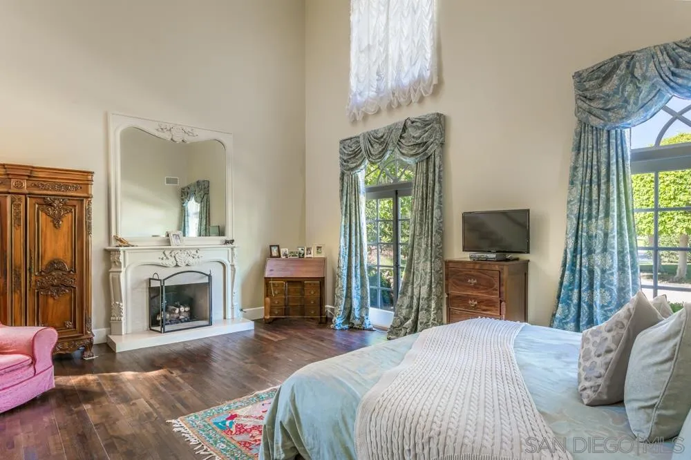 6645 Via Dos Valles Rancho Santa Fe, CA 92067 - Photo 8 of 20 a bedroom with a bed and a fireplace