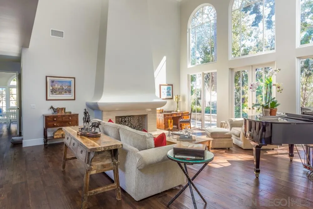 6645 Via Dos Valles Rancho Santa Fe, CA 92067 - Photo 9 of 20 a living room with furniture a fireplace and a large window