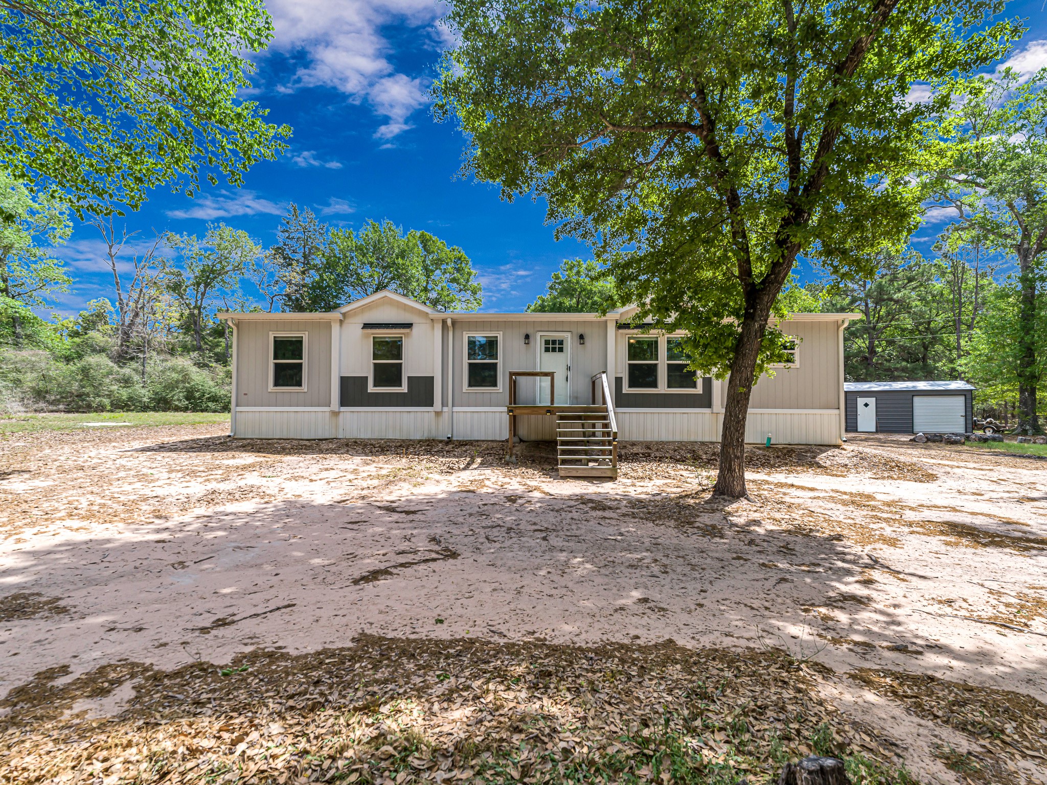 1047 Jimbob Lane New Ulm, TX 78950 - Photo 1 of 18 Welcome Home to Jim Bob Lane! This charming tied down, manufactured home, built in 2020, sits on a spacious, tree shaded lot. Enjoy country living with plenty of privacy where the only visitors will be deer & wildlife! The front exterior is a blank canvas for the landscaping of your dreams! Imaging the possibilities! Wait until you see inside!
