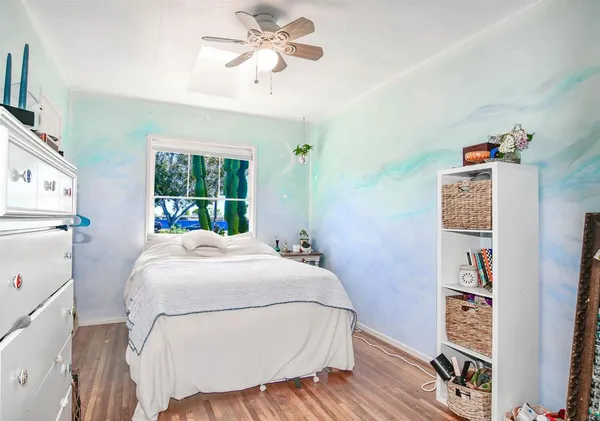 a bedroom with a bed and a bookshelf