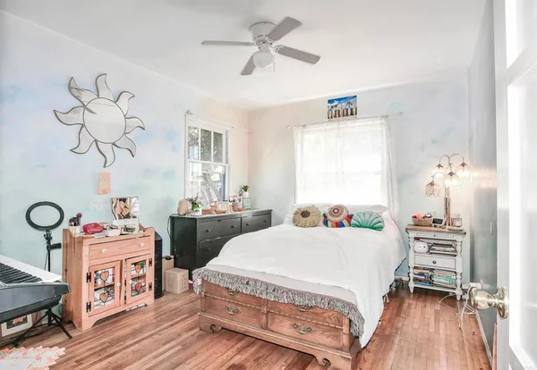 a bedroom with two beds and a chandelier