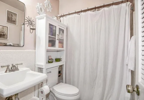a white toilet sitting next to a bathroom sink