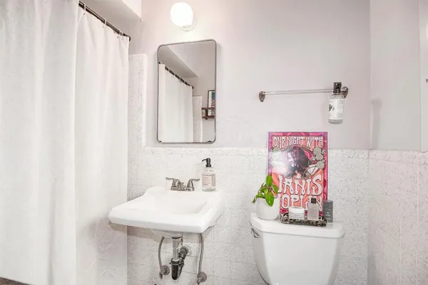 a bathroom with a sink toilet and shower