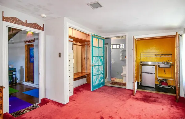 a bathroom with a toilet a sink and a large window