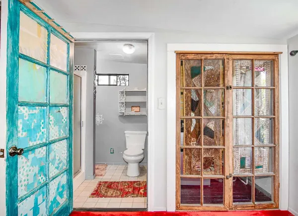 a bedroom with a bed and a large window with outer view