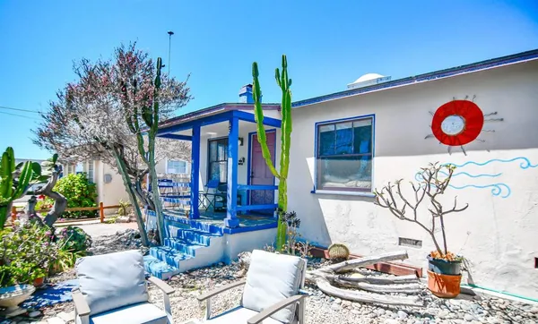 a view of a chairs and table in backyard