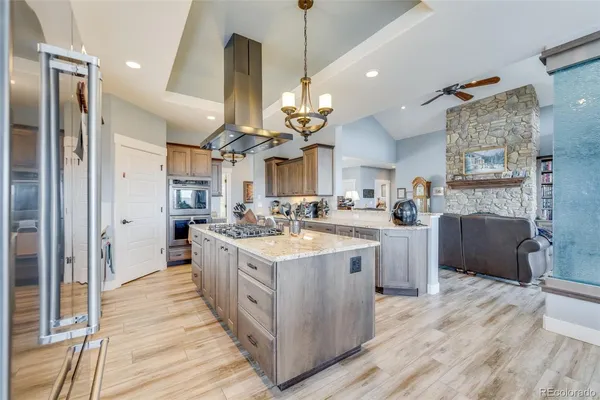 a view of a kitchen with granite countertop a sink stainless steel appliances and cabinets