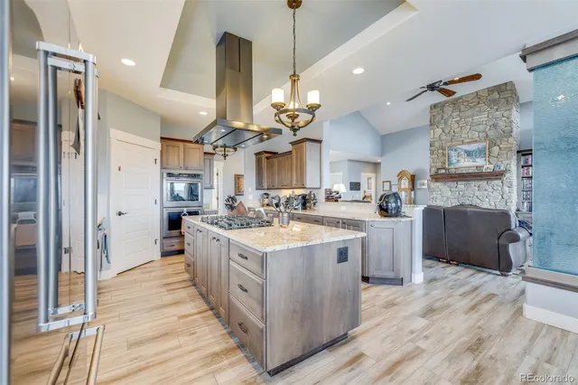 a view of a kitchen with granite countertop a sink stainless steel appliances and cabinets