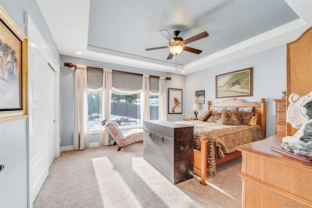 a bedroom with a large bed and a chandelier