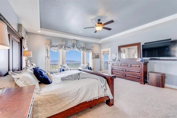 a spacious bedroom with a bed and wooden floor
