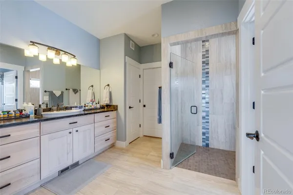a view of a bathroom with a walk in closet and window