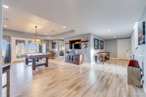 a living room with fireplace furniture and a wooden floor