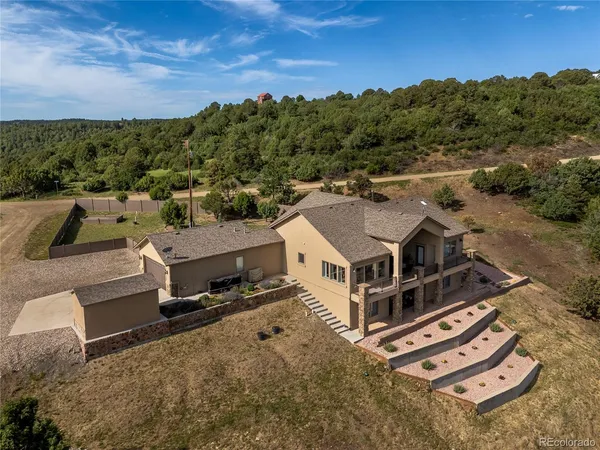a aerial view of a house with a yard