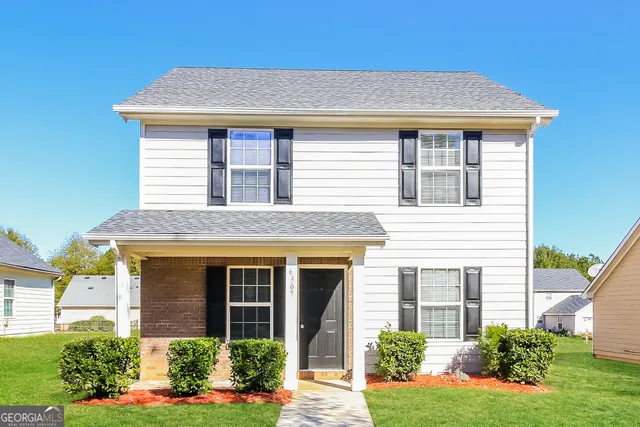 a front view of a house with garden