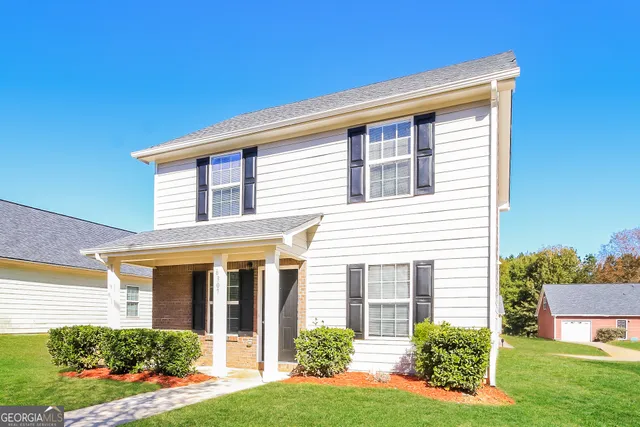a front view of a house with a yard