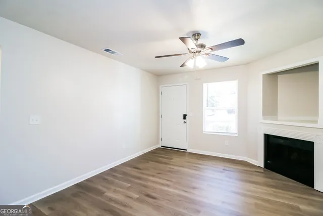 wooden floor in an empty room with a window