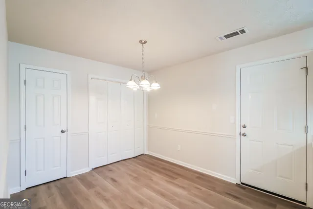 a view of a chandelier fan and entryway