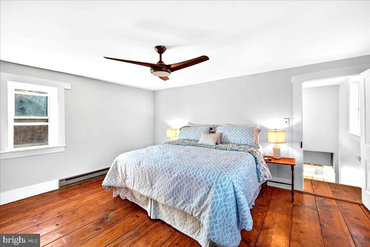290 Riley Hollow Road Huntly, VA 22640 - Photo 58 of 148 a bedroom with a bed and wooden floor