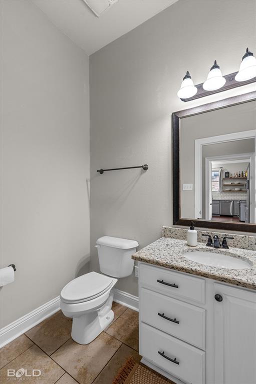 946 Maize Street Bossier City, LA 71111 - Photo 28 of 39 a bathroom with a granite countertop toilet sink and mirror