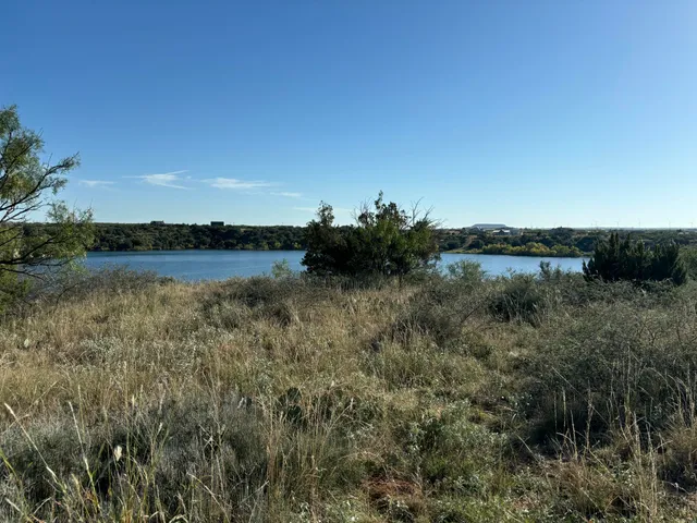 a view of a lake with houses in the back