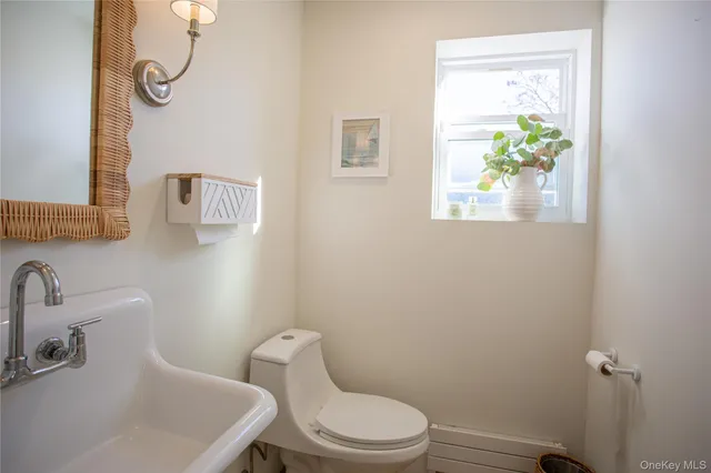 a white toilet sitting next to a bathroom sink