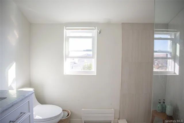 a white toilet sitting next to a bathroom sink
