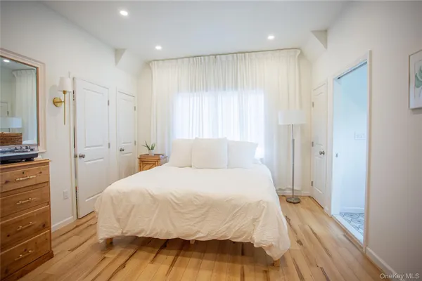 a bedroom with a bed and a mirror