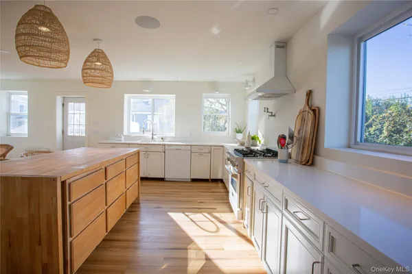 a kitchen with a sink appliances and a large window