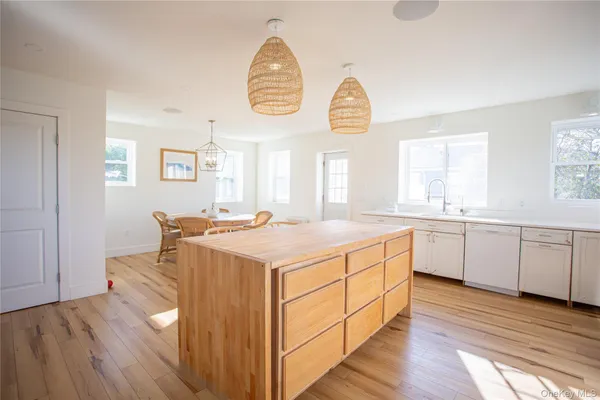 a kitchen with a sink cabinets and wooden floor