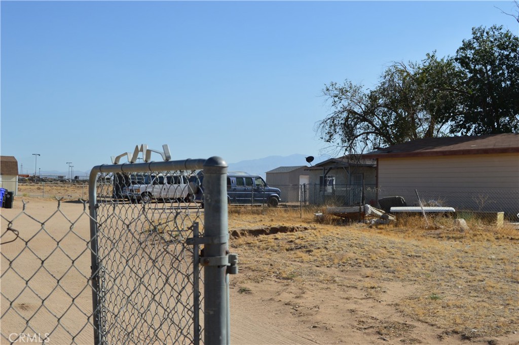 12065 Aztec Lane Adelanto, CA 92301 - Photo 20 of 64 a backyard of a house with table and chairs