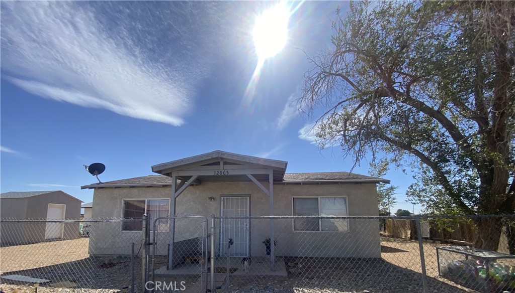 12065 Aztec Lane Adelanto, CA 92301 - Photo 2 of 64 a front view of a house with parking area
