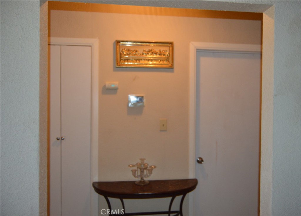 12065 Aztec Lane Adelanto, CA 92301 - Photo 33 of 64 a view of a hallway with table and mirror